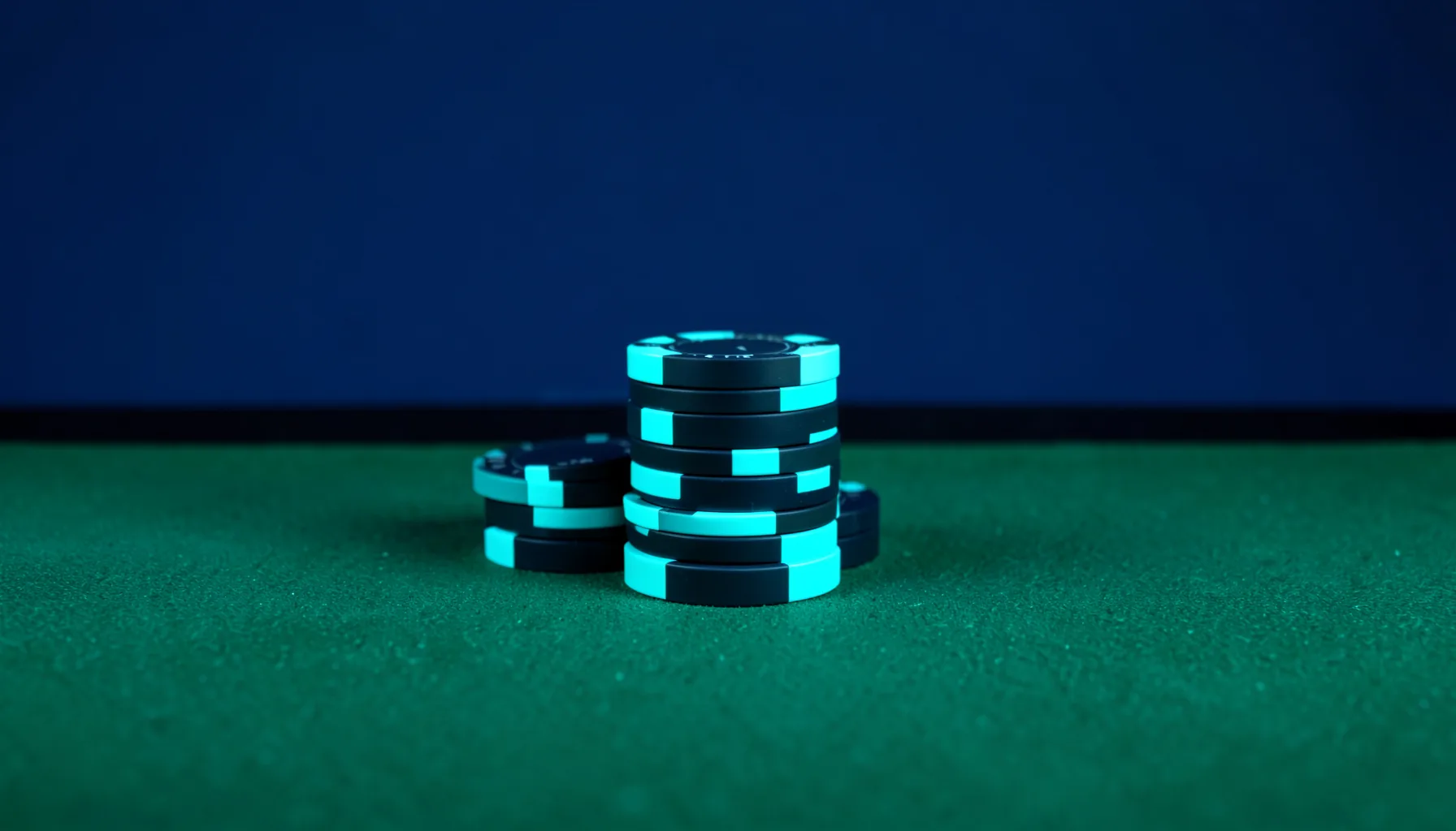 Studio photograph of stacked casino chips and a green felt table, lit in deep navy with bright cyan accents, evoking a modern gaming interface.